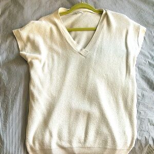 V-neck cream vest. Fits medium to large listed as Large.